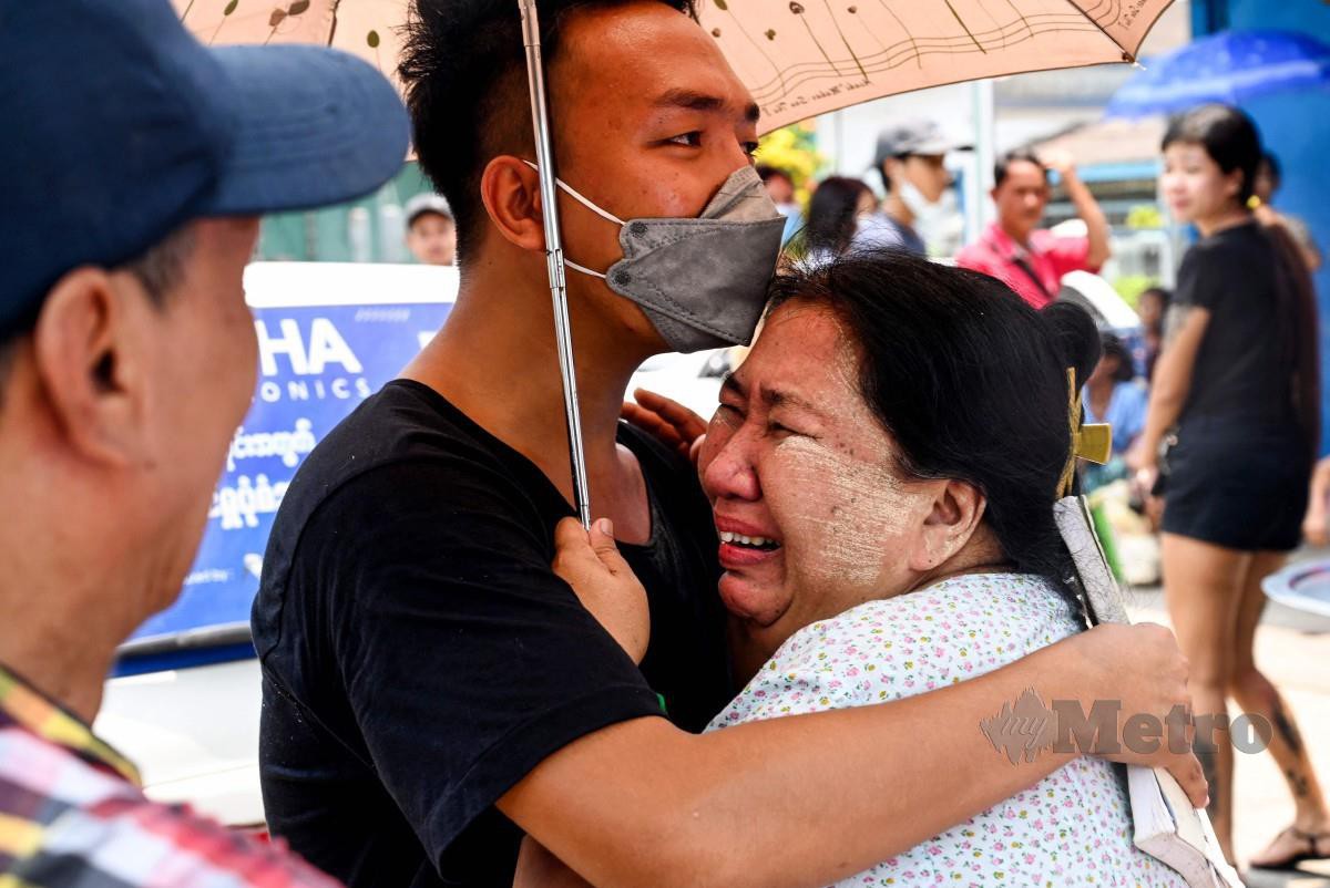 SEORANG lelaki memeluk ahli keluarganya selepas dibebaskan dari penjara di Yangon. FOTO AFP