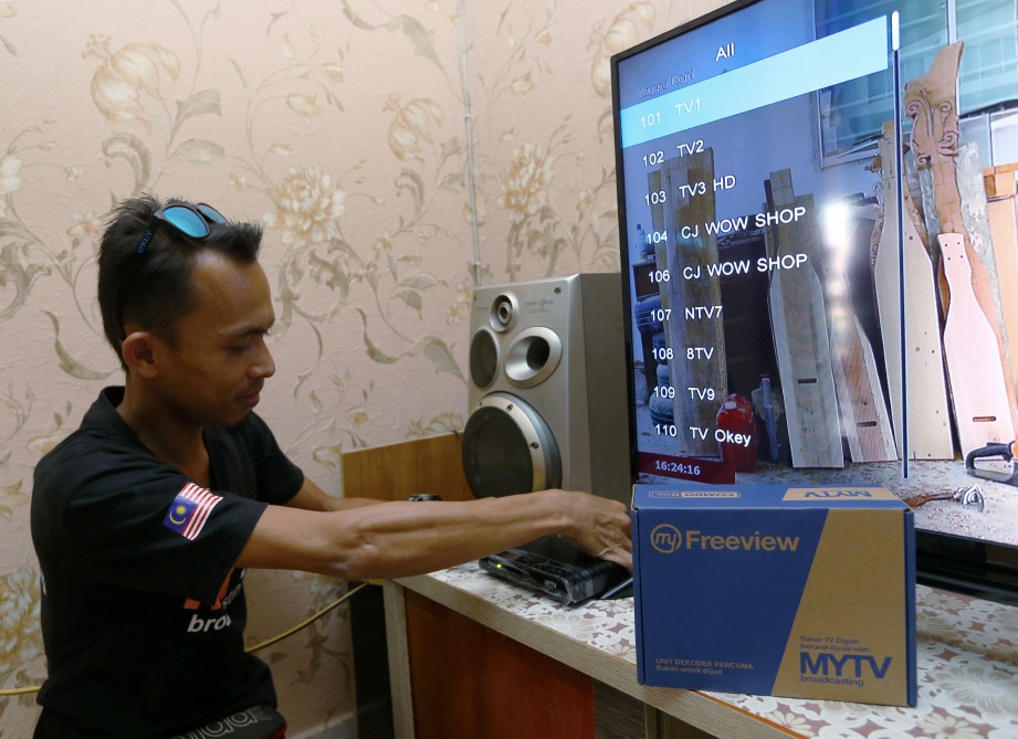 Juruteknik MYTV, Mohammed Noor Redhuan Mat Tarzan memasang dekoder TV Digital myFreeview di rumah pelanggannya di Cyberjaya baru-baru ini. Foto Rosela Ismail