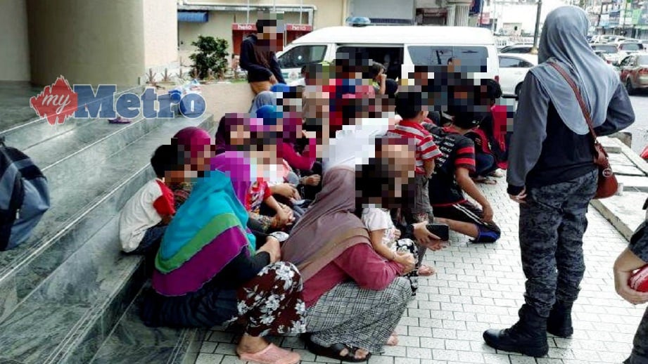 PATI wanita dan kanak-kanak yang ditahan dalam Op Mega 3.0 di perkampungan Kemboja Kampung Che Lijah menunggu di perkarangan pejabat Unit Penguatkuasa Jabatan Imigresen Jalan Banggol, Kuala Terengganu untuk dibawa ke Depoh Tahanan Imigresen Ajil, Kuala Berang. FOTO Zaid Salim