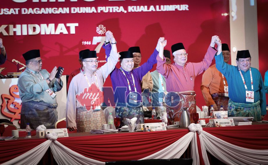 Najib bersama Ahmad Zahid, Hishammuddin dan Setiausaha Agung UMNO, Datuk Seri Tengku Adnan Tengku Mansor mengangkat tangan selepas usul jawatan Presiden dan Timbalan Presiden UMNO tidak dipertandingkan pada Perhimpunan Agung UMNO 2017 di Pusat Dagangan Dunia Putra (PWTC), Kuala Lumpur. FOTO Muhd Zaaba Zakeria 