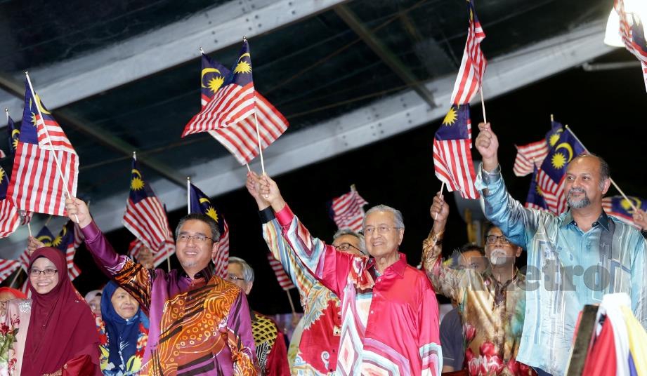 DR Mahathir mengibarkan Jalur Gemilang pada Majlis Pelancaran Bulan Kebangsaan dan Kibar Jalur Gemilang 2019 bertemakan ‘Sayangi Malaysiaku: Malaysiaku Bersih’ di Dataran Pahlawan, Banda Hilir, Melaka, malam tadi. Turut kelihatan, Gobind (kanan) serta Adly (dua dari kiri). FOTO Khairunisah Lokman.