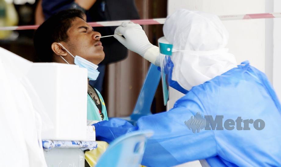 KAKITANGAN Kementerian Kesihatan Malaysia (KKM) melakukan  ujian saringan kepada pelajar Kolej Sultan Abdul Hamid susulan penularan wabak COVID-19. FOTO AMRAN HAMID