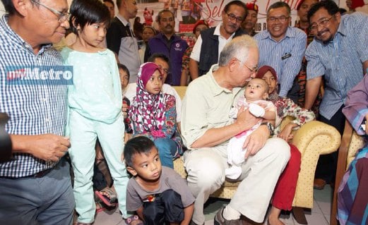Najib mencium dahi adik Nor Adifa Arissa ,4, anak kepada suami isteri yang lemas ketika bot penyelamat terbalik di Kemaman baru-baru ini. FOTO Rozainah Zakaria