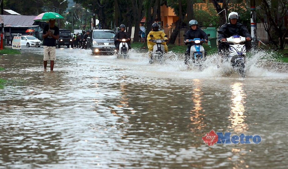 Hujan lebat sejak awal pagi menyebabkan beberapa jalan  utama berhampiran Jalan P Ramlee, Pulau Pinang, dilanda banjir kilat.  - Foto AMIR IRSYAD OMAR