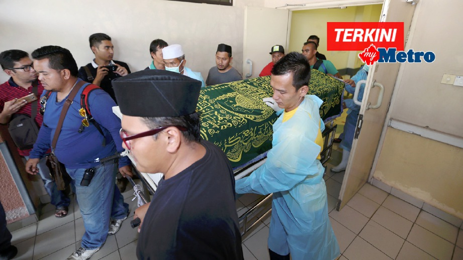 KAKITANGAN Hospital Jempol mengusung jenazah Osman Mohamed Taib, 31 untuk dibawa pulang bagi urusan pengebumian. FOTO Iqmal Haqim Rosman