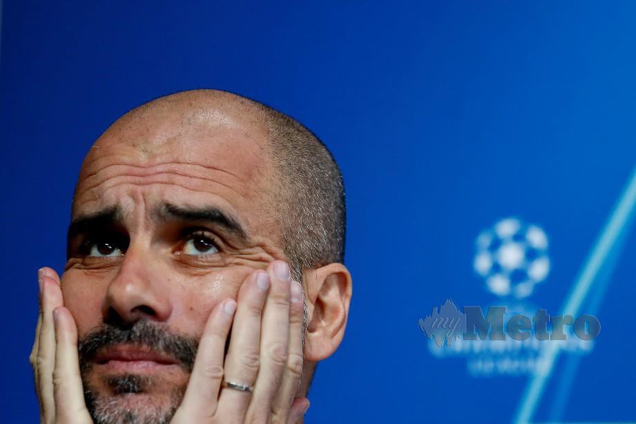 HUKUMAN yang dikenakan City sudah pasti memeningkan pengurusnya, Guardiola. FOTO Reuters