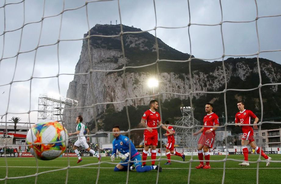 HENDRIK meraikan jaringan kemenangan Ireland sementara pemain Gibraltar dipalit kecewa. - FOTO Reuters 