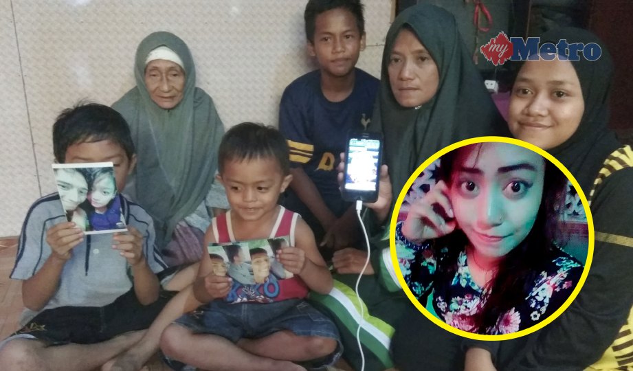 NORSIMAH  (dua kanan) bersama keluarga menunjukkan gambar Nur Fatin Nadhirah (gambar kecil). FOTO Mohd Shukor Amin