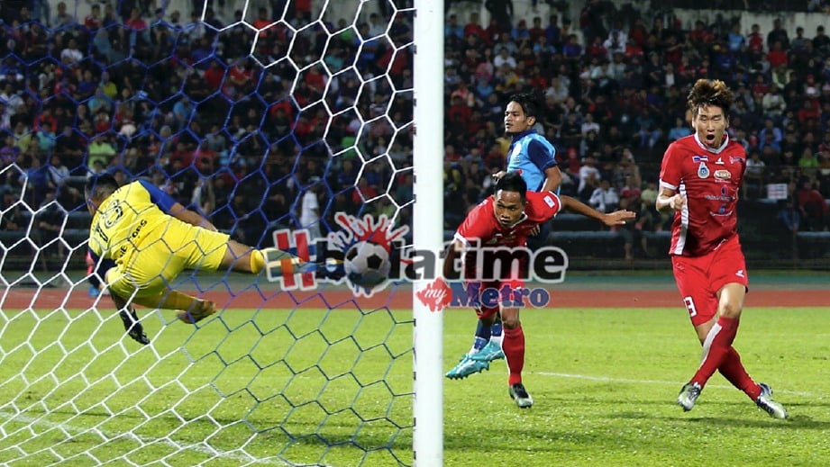 JAENYONG (kanan) menjaringkan gol ketika bertemu PDRM dalam saingan Liga Perdana di Stadium Likas. -Foto MALAI ROSMAH TUAH