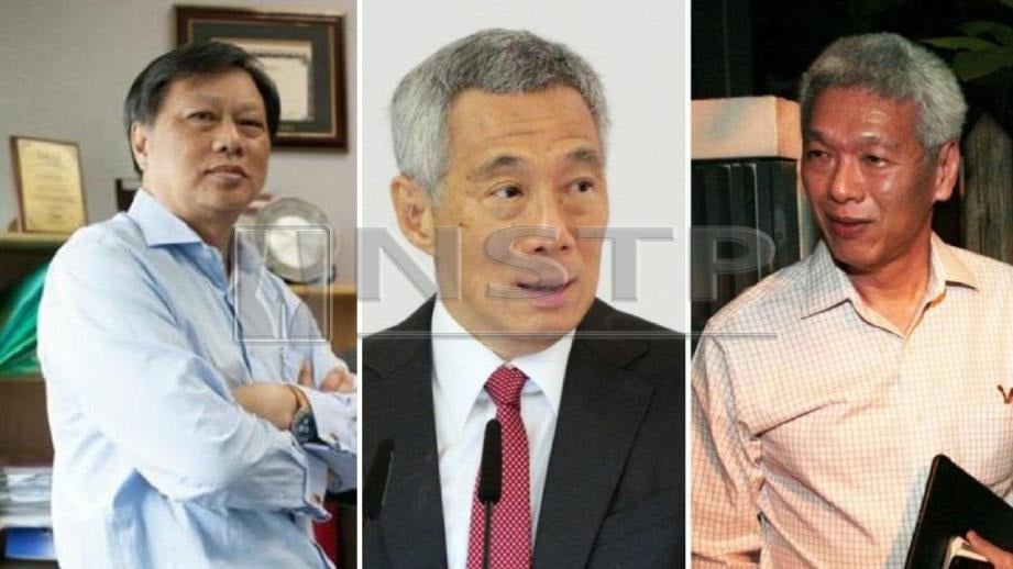 Hsien Yang (kanan) memberi sejumlah wang kepada Sze Hian (kiri) yang menghadapi saman fitnah Perdana Menteri, Hsien Loong. FOTO Facebook