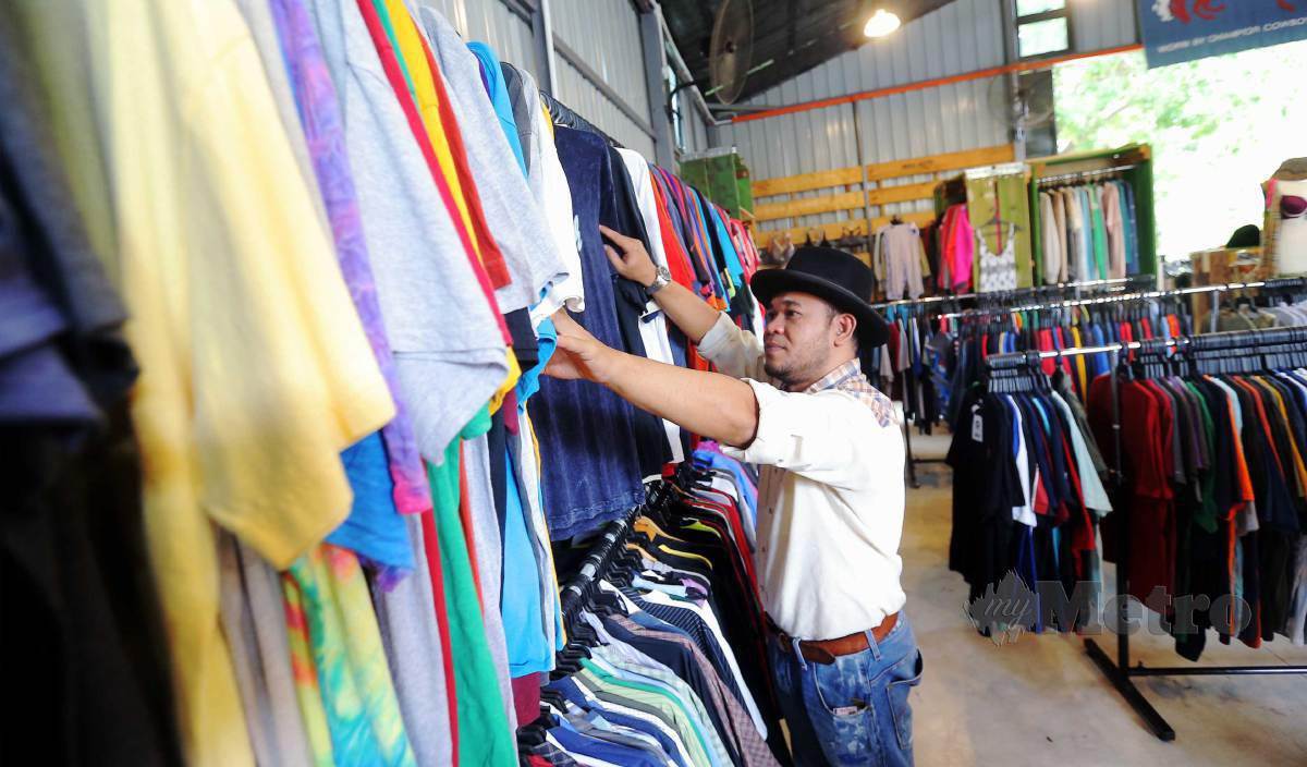 AHMAD Baihaki melihat koleksi pakaian di kedainya. FOTO Saifullizan Tamadi