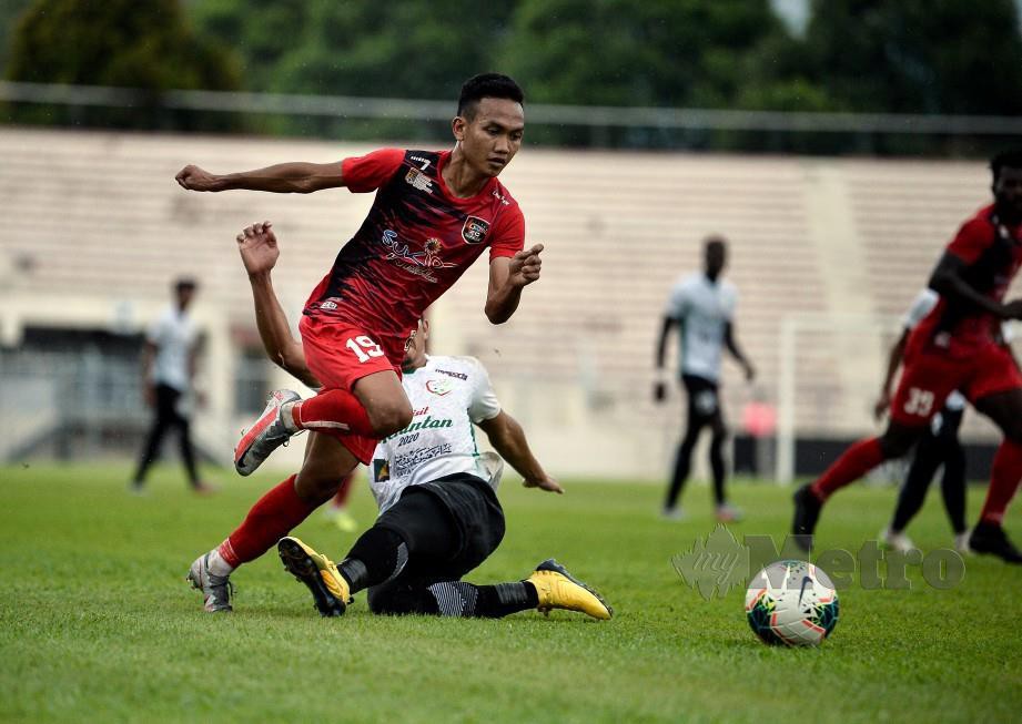 Pemain UKM Muhamad Baqiuddin Shamsudin (kiri) melepasi kawalan pemain Kelantan United, Mohammad Ab Aziz Ismail pada aksi Liga Perdana. FOTO Bernama 