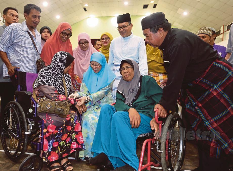 DR Wan Azizah  (tengah) bersama Norhanane Mohd Noor, 42, (kiri) dan Nor Asmah Jamburi, 55, (kanan) pada program ‘Salam Iftar bersama OKU’ anjuran Pusat Khidmat Masyarakat DUN Pandan Indah di Dewan MPAJ Pandan Indah, Ampang, malam tadi. FOTO Zunnur Al Shafiq.