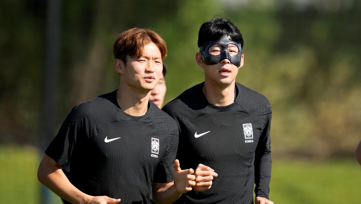 SON (kanan) memakai topeng ketika berlatih bersama rakan sepasukan sebelum menentang Uruguay. FOTO AP 