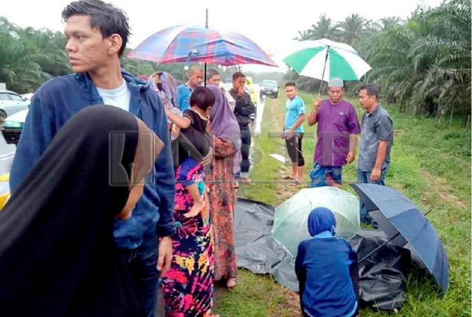 ORANG ramai termasuk ahli keluarga  menunggu jenazah mangsa, Zakaria Jusoh, 71 yang dipercayai mangsa langgar lari di tepi Jalan Gua Musang-Kuala Krai. FOTO Ramli Ibrahim