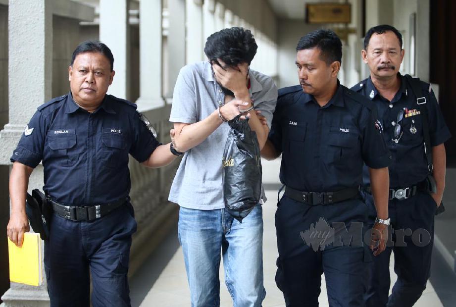 PEMBANTU Jurutera Audio, Zulkifli Taib, 38 (tengah) diiringi polis selepas diperintahkan oleh mahkamah untuk ke Hospital Bahagia Ulu Kinta, Perak berikutan beliau mencederakan isterinya yang sarat mengandung minggu lalu di Mahkamah Sesyen Jenayah 15, Kompleks Mahkamah Kuala Lumpur. FOTO Mohd Khairul Helmy Mohd Din
