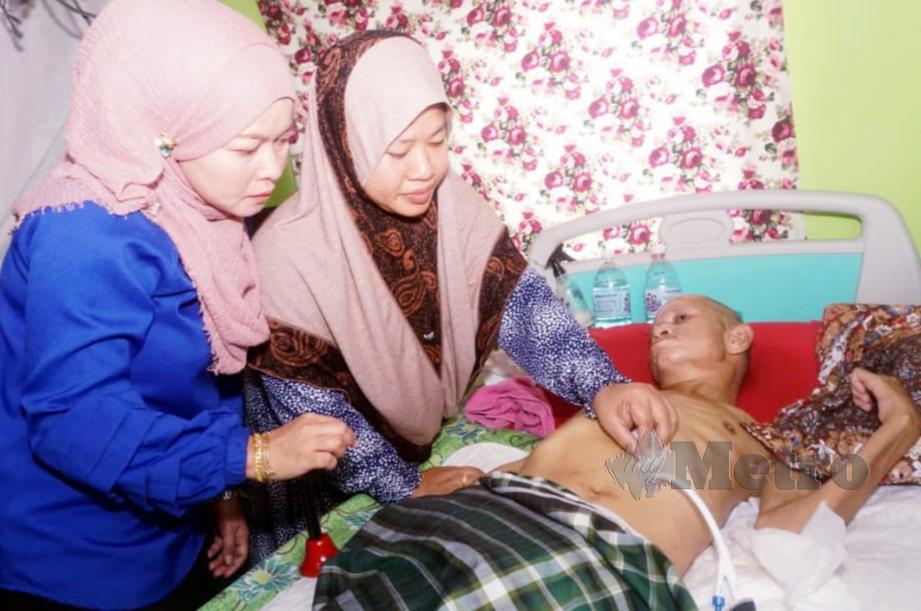 CHEPutih Saleh, 37,  memberi minum susu kepada suaminya Khairul Amri Ahmad,46, melalui tiub di rumahnya di Kampung Kampung Changkat Nering, Pendang. FOTO Noorazura Abdul Rahman