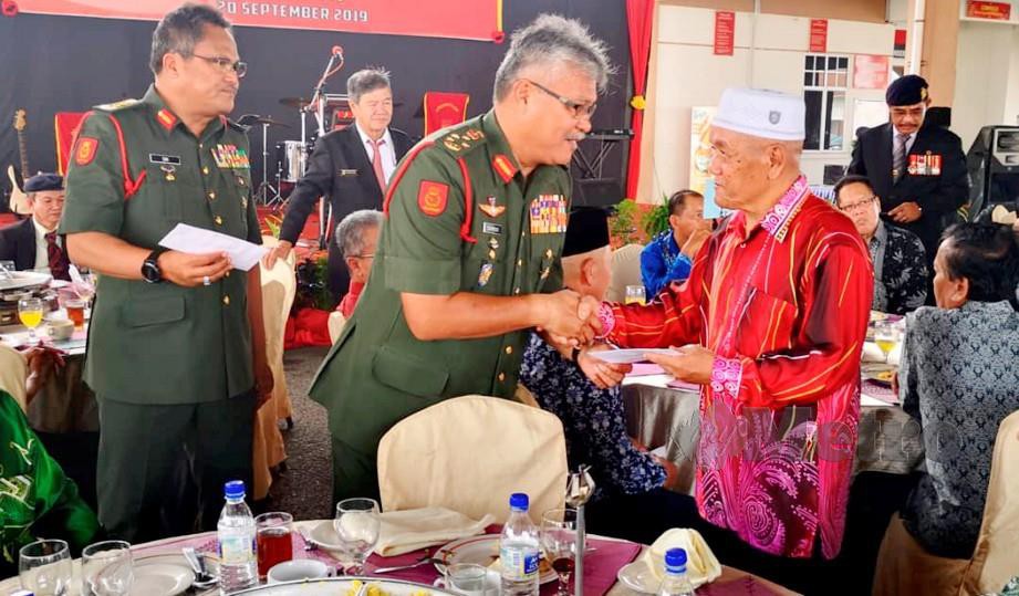 Zamrose menyampaikan sumbangan kepada veteran tentera yang cedera ketika operasi ketika bertugas sebelum ini di majlis Sambutan Hari Pahlawan dan Penyampaian Sumbangan kepada Anggota Tentera Cedera di Kem Muara Tuang, Kota Samarahan. Foto Mohd Roji Kawi 