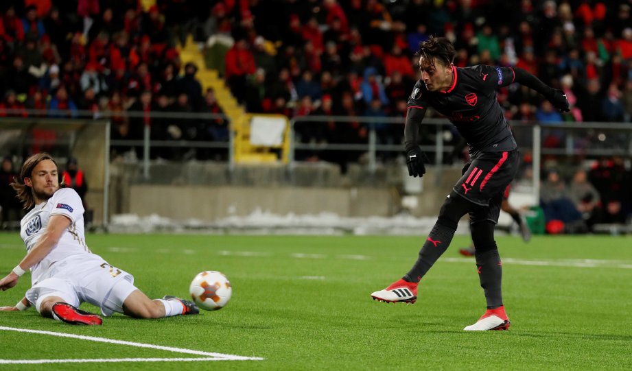 GAYA pemain tengah Arsenal, Mesut Ozil (kanan) ledak gol ketiga pada saingan Liga Europa, awal pagi tadi. - Foto Reuters