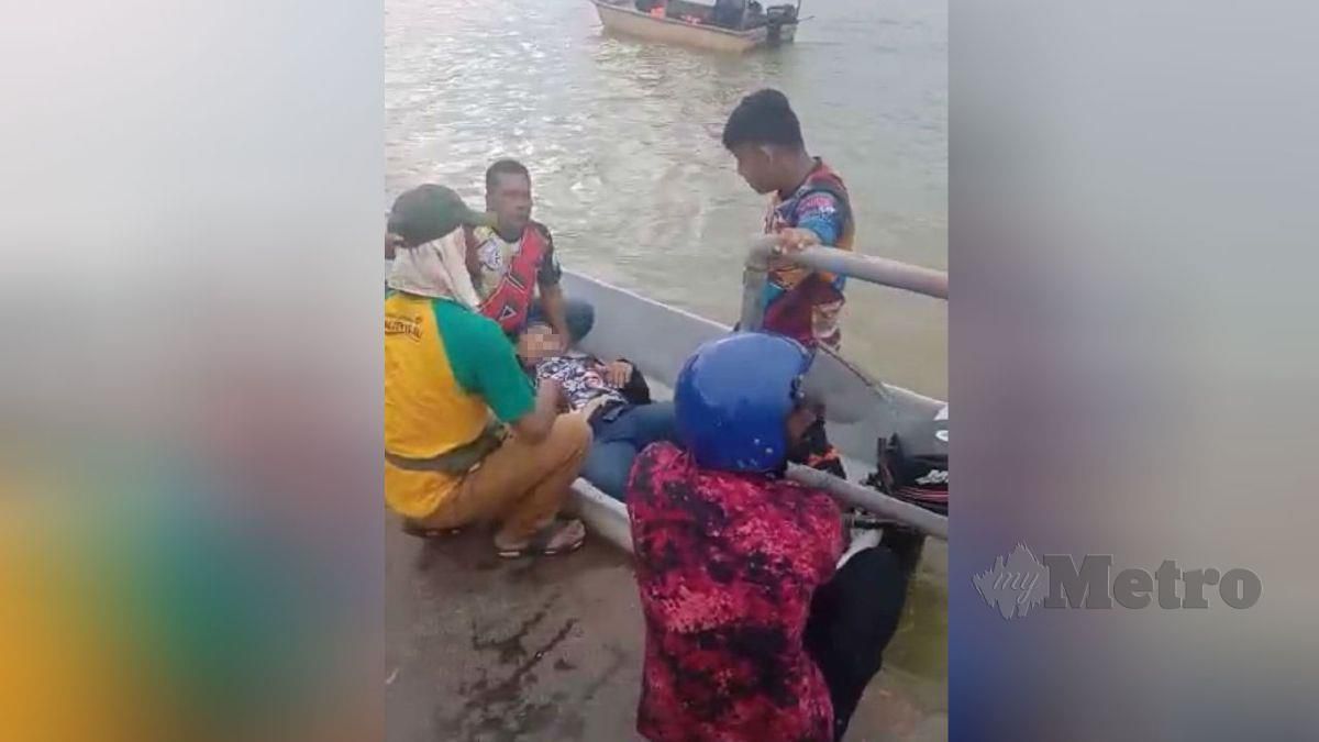 ZUNAIDEE (baju kuning) membantu lelaki yang terjatuh ke Sungai Perak selepas terbabit kemalangan di Jambatan Sultan Yusof. FOTO ihsan Zunaidee Mohd Yusuf
