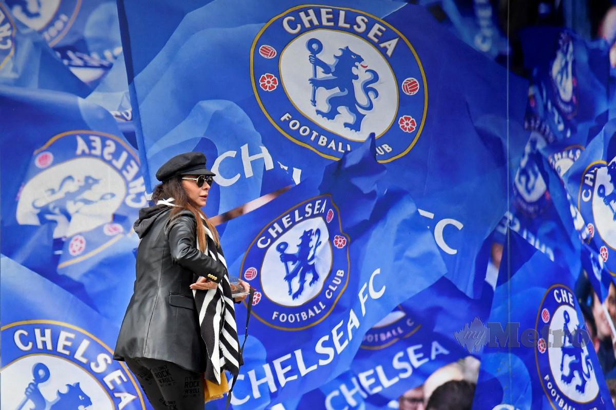 SEORANG wanita melintasi kedai barangan Chelsea di Stamford Bridge. FOTO Reuters