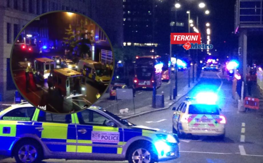 GAMBAR yang dirakam dengan telefon bimbit ini memaparkan kereta polis menyekat laluan masuk ke London Bridge, di tengah London. FOTO AFP 