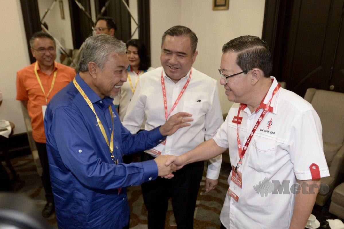 PENGERUSI Barisan Nasional Datuk Seri Dr Ahmad Zahid Hamidi bersalaman dengan Guan Eng (kanan) sambil diperhatikan Setiausaha Agung DAP, Anthony Loke ketika Persidangan Parti DAP 2023. FOTO Aizuddin Saad 