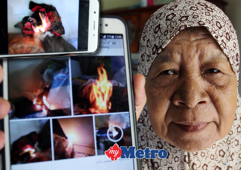 Faridah Sulaiman, 75, menunjukkan gambar kebakaran dalam biliknya akibat ‘api misteri’ di Kampung Penambang Mas, Kota Bharu. - Foto NIK ABDULLAH NIK OMAR