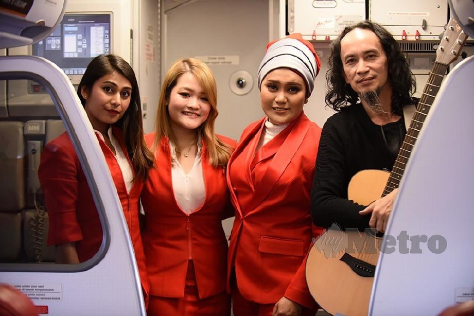 AZHARINA bersama Korie menghiburkan penumpang pesawat AirAsia.