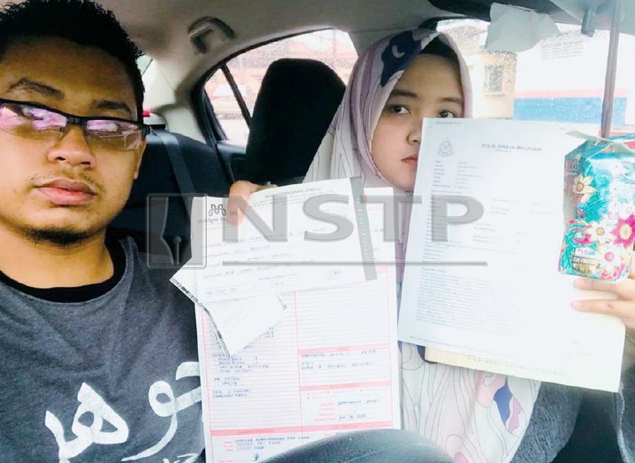 Sharifah Nuruladawiah (kanan) menunjukkan laporan polis. FOTO Ihsan Sharifah Nuruladawiah 