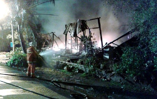 ANGGOTA bomba memadam kebakaran rumah Noraini di Kampung Jeram Batu, awal pagi  semalam.