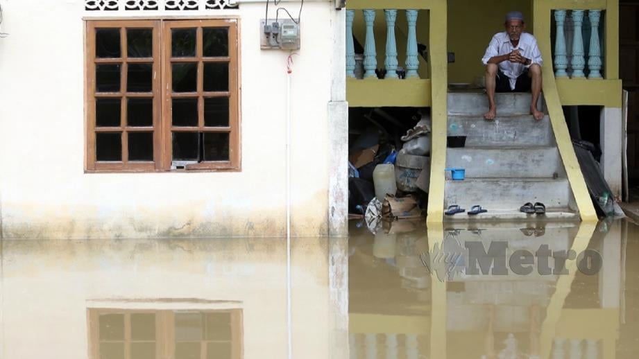 ABDUL Salleh Mat Kasri, 73, melihat keadaan rumahnya yang dinaiki air akibat hujan lebat dan fenomena air pasang besar, di Kampung Parit Mahang, Kuala Selangor. FOTO Saddam Yusoff.