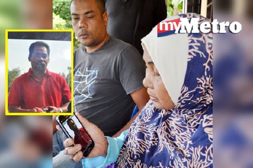 Fatimah (kanan) menatap wajah  Mohd Shukri  yang terbunuh di Abu Dhabi di telefon bimbit bersama Faizol. FOTO Bernama
