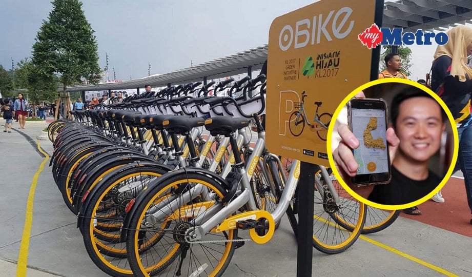 DERETAN basikal oBike yang sedia untuk disewa. Gambar kecil, Ian menunjukkan aplikasi oBike di Malaysia. FOTO Saifullizan Tamadi.