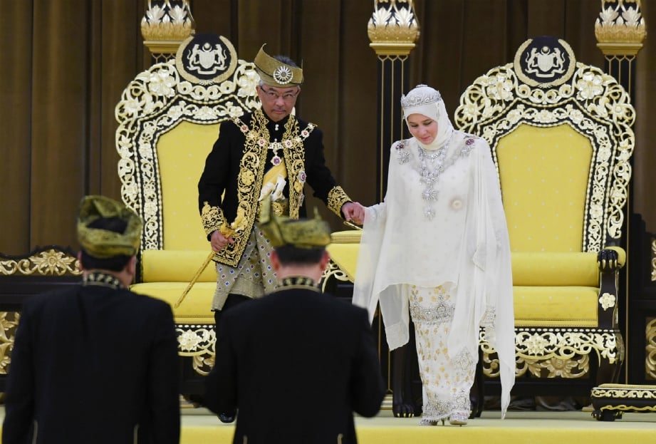  Al-Sultan Abdullah berkenan memimpin tangan Tunku Azizah Aminah Maimunah Iskandariah untuk berangkat keluar dari Balairung Seri selepas Istiadat Pertabalan baginda di Istana Negara, semalam. FOTO BERNAMA 