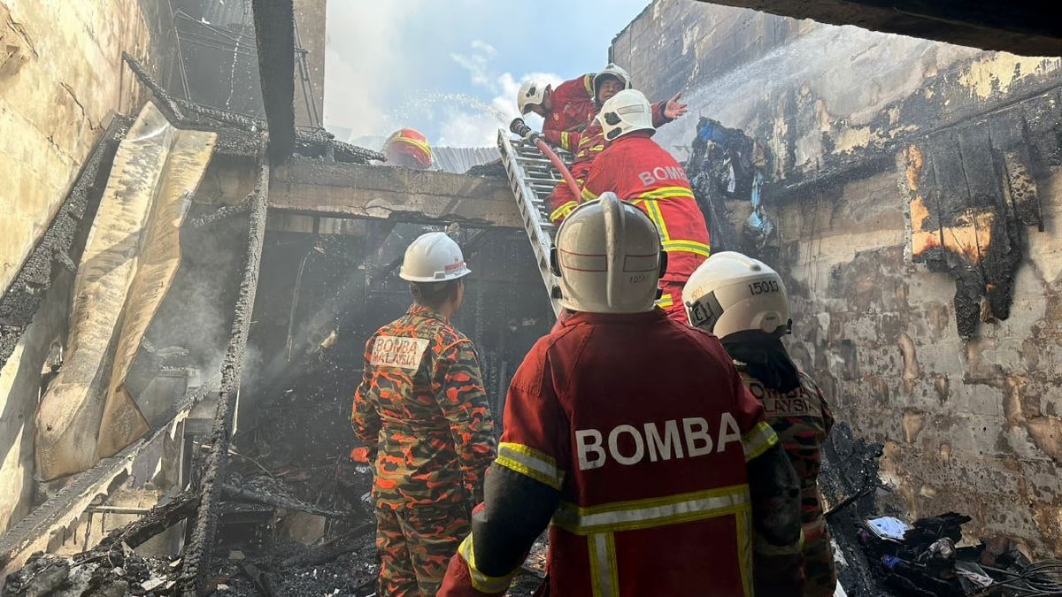 BOMBA membantu memadam kebakaran satu daripada lima rumah teres dua tingkat di RPR Batu Kawa, Kuching, terbakar hari ini. FOTO Ihsan JBPM