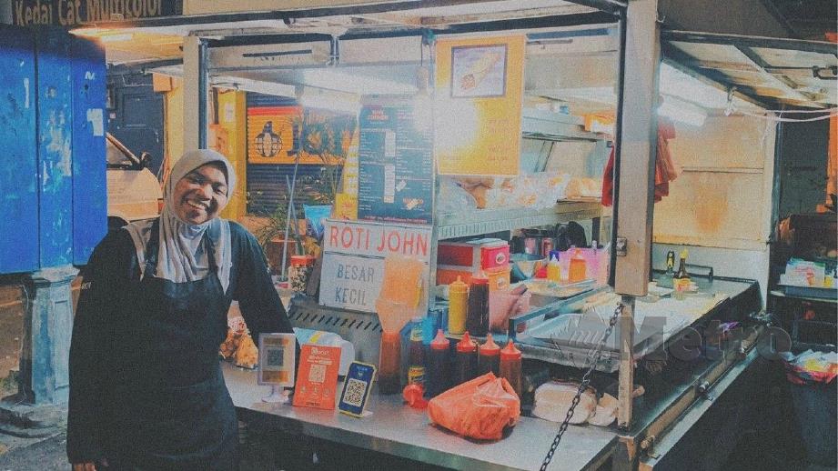 NURUL A’in memilih mencari rezeki dengan menjual burger dan roti ‘john’ peninggalan arwah bapanya. FOTO Ihsan  Nurul A’in Azman