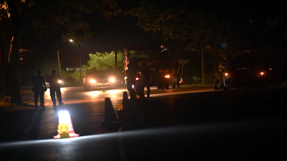 ANGGOTA polis dari IPD Kangar melakukan Sekatan Jalan Raya di daerah Sanglang malam tadi. FOTO BERNAMA