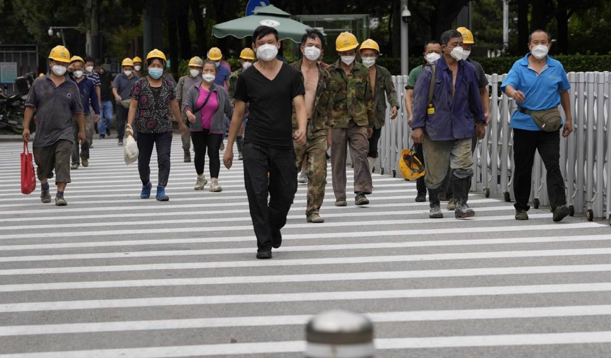 PEKERJA binaan memakai pelitup muka ketika memasuki tapak pembinaan di Beijing, China. FOTO AP