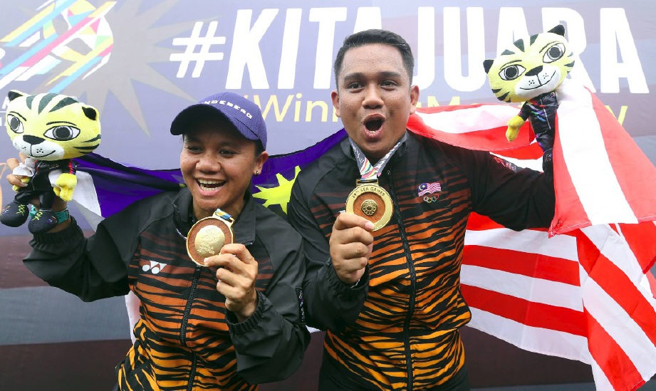 JUWAIDI (kanan) dan Fatin bersama pingat emas yang dimenangi.