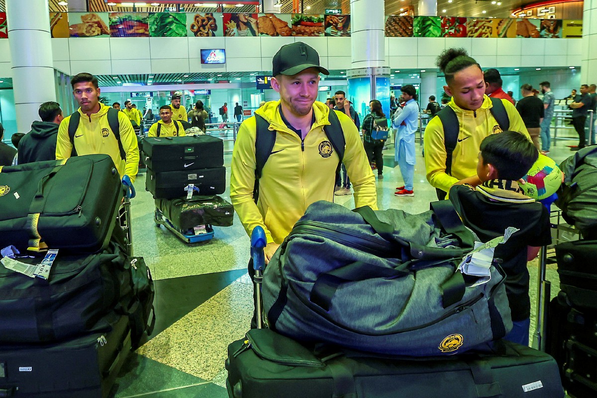 DARREN Lok (tengah) bersama rakan sepasukan tiba di Lapangan Terbang Antarabangsa Kuala Lumpur (KLIA) malam tadi selepas beraksi pada kempen kelayakan Piala Dunia 2026/Piala Asia 2026. FOTO BERNAMA