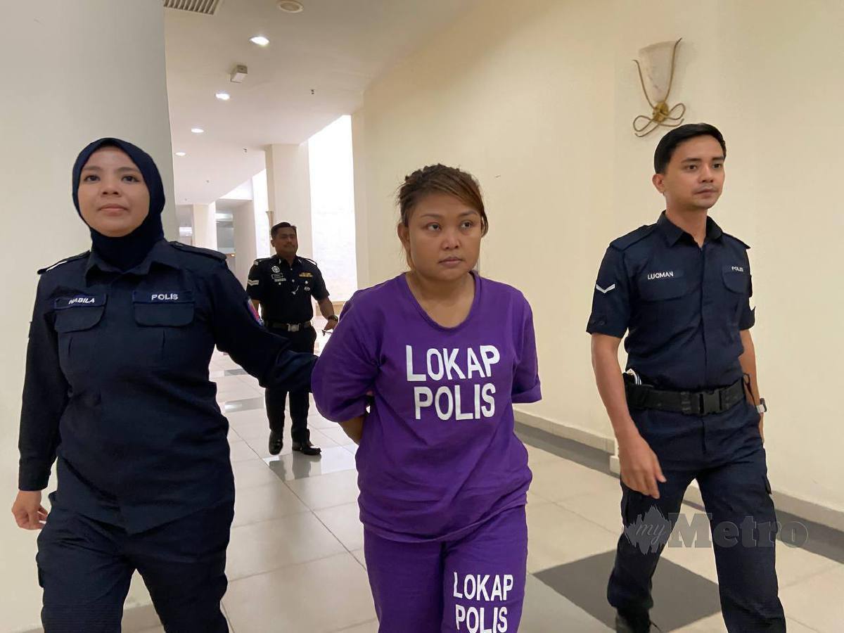 Tertuduh diiringi polis selepas didenda RM2,800 kerana melakukan aktiviti persundalan dalam pondok di kebun. FOTO Alias Abd Rani