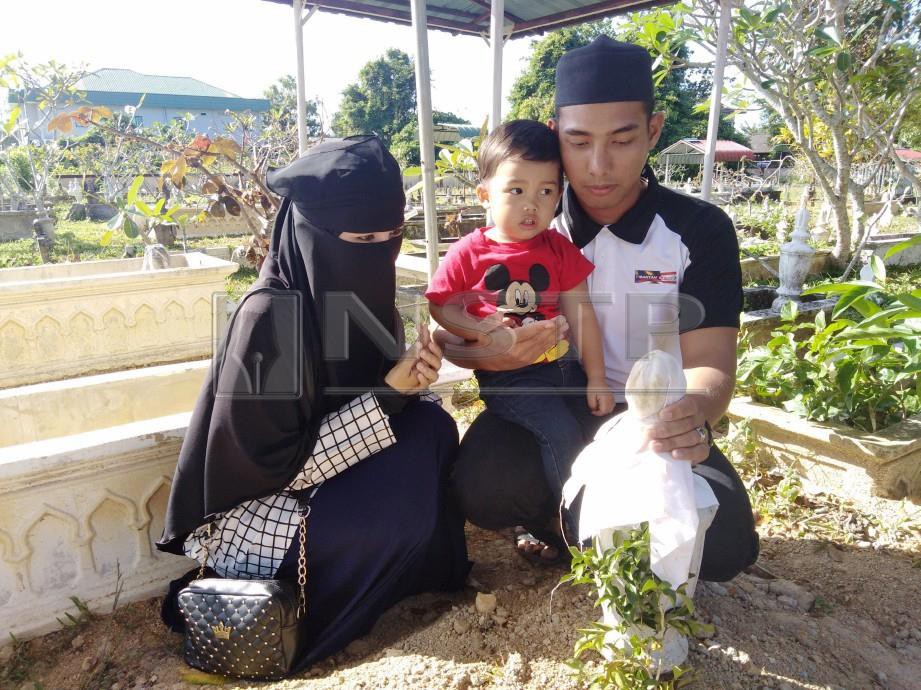 OMAR  bersama isteri dan anak lelakinya menziarahi pusara arwah Abdul Bari Asyraf di Tanah Perkuburan Islam Kampung Merbau Patah.
