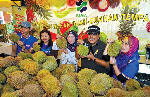 KELUARGA Sabah FM menunjukkan buah durian.