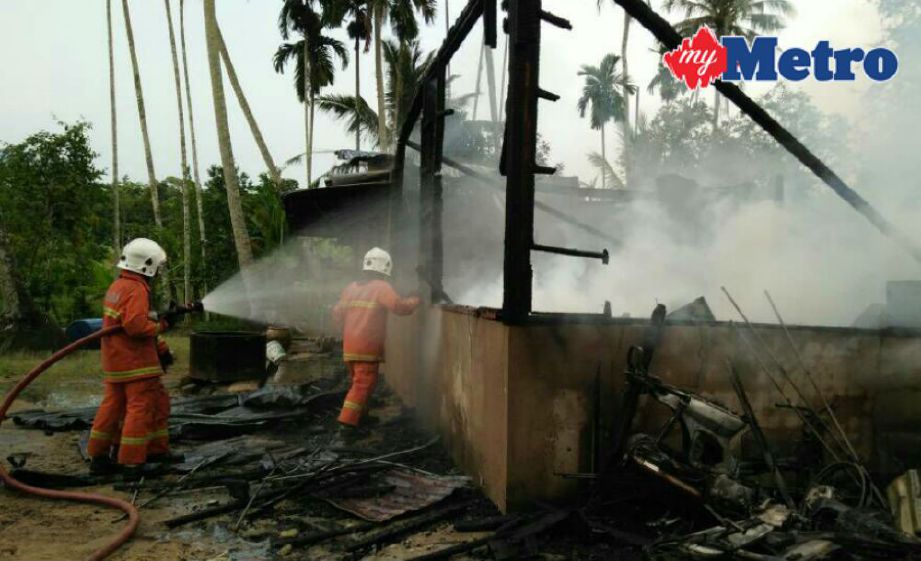 Anggota bomba memadamkan kebakaran rumah di Kampung Sirako, Pulai, Baling, hari ini.