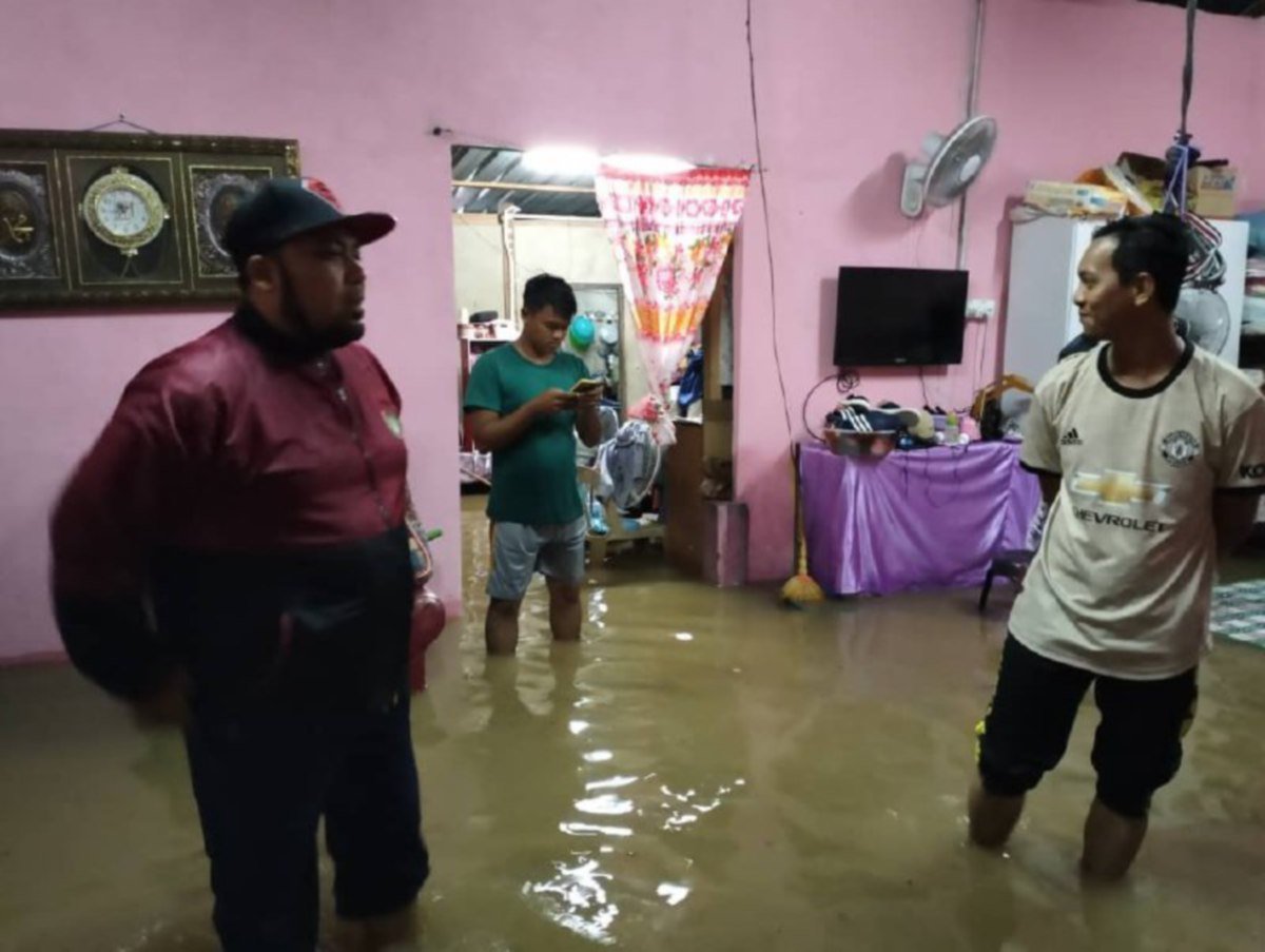 ANGGOTA APM dan sukarelawan meninjau rumah yang dinaiki air selepas hujan melanda kawasan Pauh Putra di Arau. FOTO Ihsan Pembaca