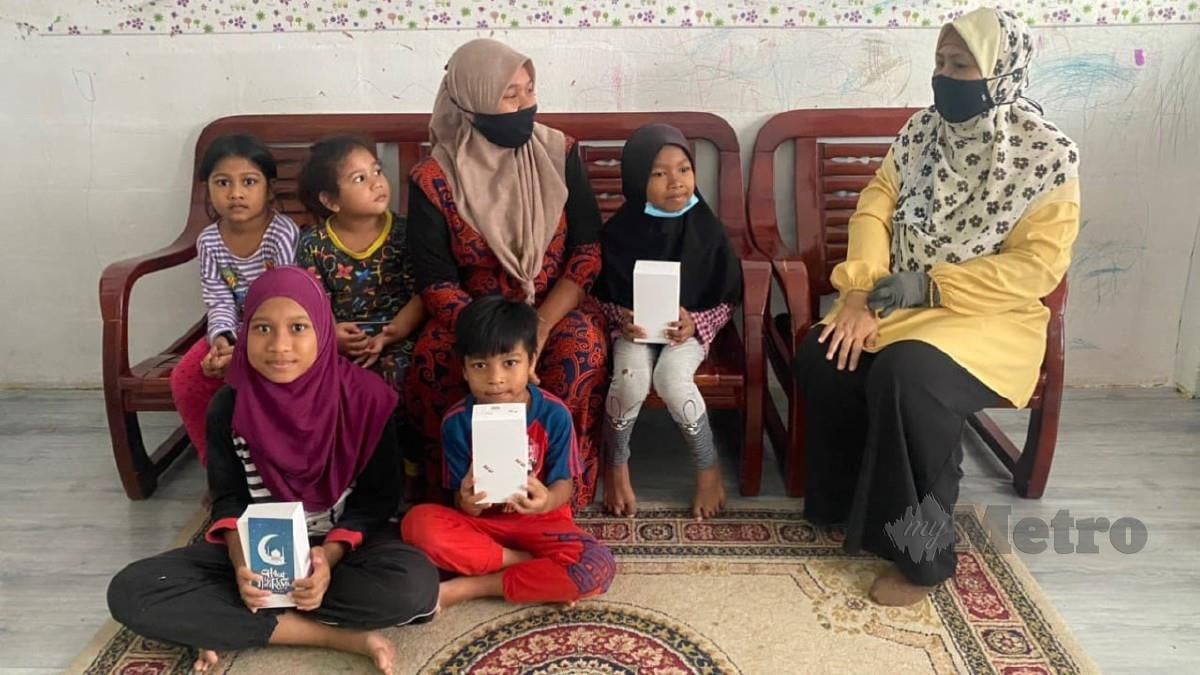HALIZA (kanan) menziarahi keluarga Salimah dan menyumbangkan tiga telefon bimbit serta bantuan kewangan, hari ini. FOTO Murnaena Muhammad Nasir