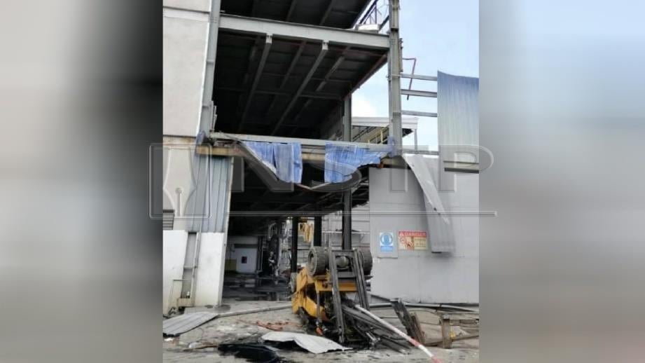 KEADAAN forklift yang terbalik selepas terjatuh dari tingkat 4 bangunan kilang di Perai, hari ini. FOTO Ihsan JBPM