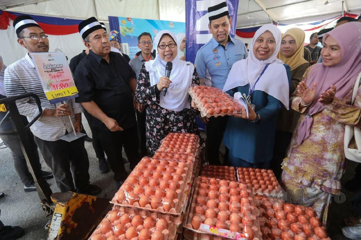 FUZIAH (tiga kiri) semasa meninjau harga telur selepas merasmikan Program Jelajah Jualan Rahmah di tapak pasar malam Tok Adis, Kuala Ibai. FOTO Ghazali Kori