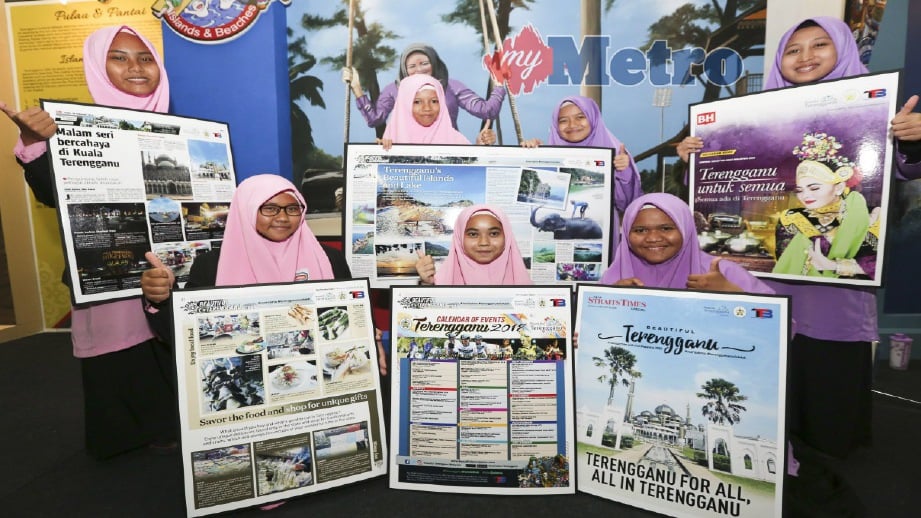 MURID Sekolah Kebangsaan Padang Kemunting menunjukkan sisipan keluaran khas Beautiful Terengganu di Kompleks Sukan Negeri, Kuala Nerus, hari ini. FOTO Ghazali Kori